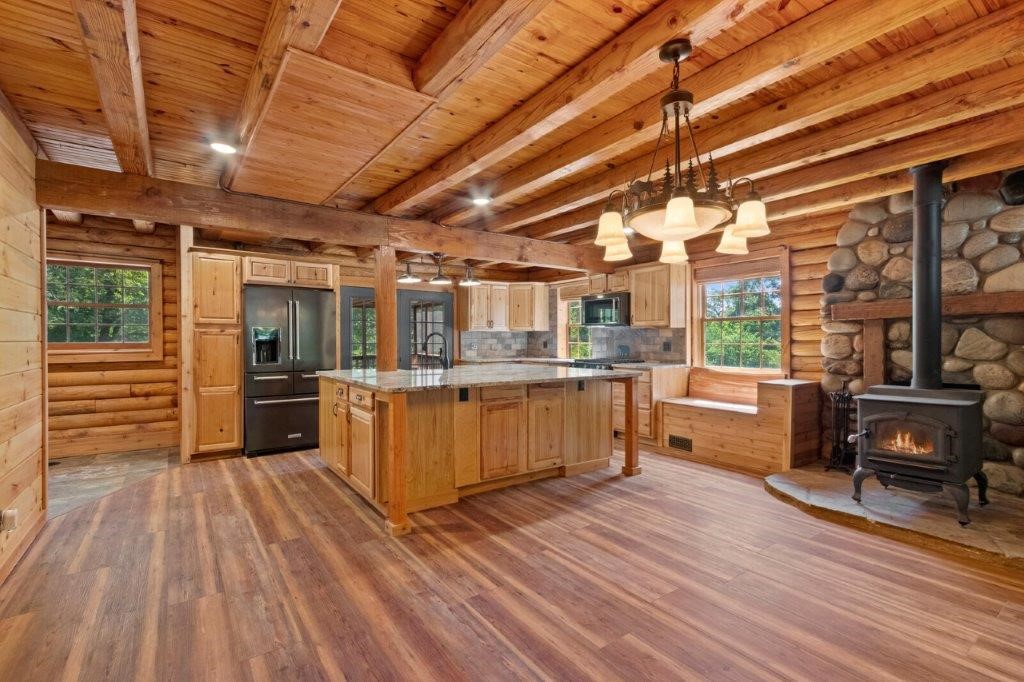 Your spring garden is waiting for you at this charming log cabin on 5 Acres. You will love this totally renovated home. Complete with gourmet kitchen and huge island that opens up to main living area perfect for entertaining. Master en-suite with large soaking tub and oversized shower. The upstairs flex space perfect for your home office or reading nook. In-law apartment or teen quarters with kitchenette, living and laundry with private entrance at lower level. Enjoy the peace and quiet from the screened in deck and watch the deer frolic and play, or just enjoy rocking on the front porch and hear nature sing. Pinterest will be jealous of the custom chicken house and additional outbuildings. Tons of storage and ready for you to call it your cabin in the woods.
