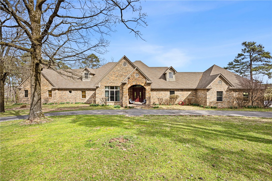 This custom-built home offers around 4,500 square feet of comfortable living space with a country feel. Set on 30 acres of rolling pasture with two ponds, it's a peaceful retreat with room to roam. Inside, you'll find tall vaulted ceilings with custom wood trim, a huge main living area, and a chef's kitchen with an island bar, breakfast area, and plenty of workspace. The home features three bedrooms, including a large primary suite with a massive bathroom and double walk-in closets. There's also a sunroom, office, guest half bath, wet bar, and an attached two-car garage -- all designed for relaxed, country living.