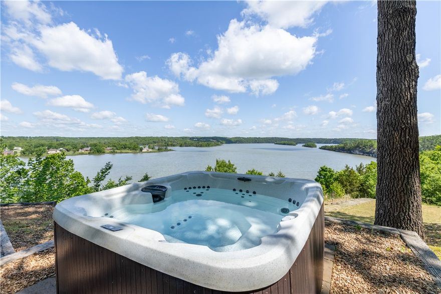 Imagine waking up every morning to panoramic views of Beaver Lake from every room in your home — then checking your VRBO income while guests enjoy the same experience. This fully furnished, off-grid-capable lakefront retreat sits on 9.3 secluded acres with 750 feet of private shoreline, making it one of NW Arkansas's most compelling live-in or investment properties. The custom-built home features soaring 14-foot cathedral ceilings, granite counters, and a split floor plan where all three bedrooms open directly onto a sweeping deck above the water. An 8-person sauna, hot tub, and fire pit keep guests coming back — and the reviews show it. With owned solar panels, a private well, and battery storage, your overhead stays low while your rental appeal stays high. Additional building sites offer room to expand with cabins or a shop. Whether you're seeking a legacy property, a high-performing short-term rental, or both — this estate delivers.