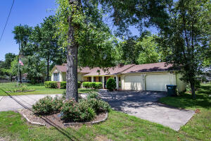 This charming private oasis on 1.14 acres that backs up to Waco Basin Park. A residence that exudes warmth and comfort. As you step inside, you're greeted by a cozy fireplace that anchors in the living room, inviting you to unwind and relax. The hardwood floors continue in the dining room. The heart of the home is the den, complete with a pellet stove and wall-to-wall windows, offering a perfect retreat for quiet evenings or informal gatherings. The kitchen has an island that's ideal for meal prep and casual dining. It's a space where memories are made over shared meals. Retire to the spacious main bedroom, a sanctuary that promises rest and rejuvenation. A large laundry room with a built-in desk serves as a versatile area for managing household tasks. The oversized two bay garage