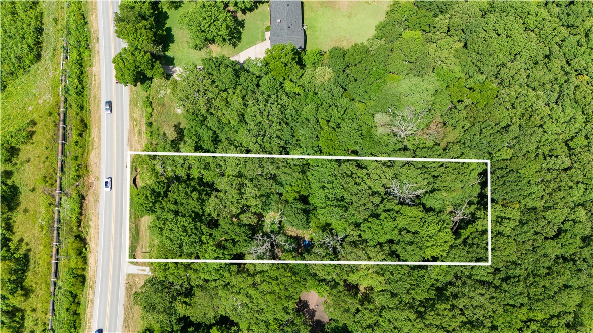 Check out this fantastic 0.78-acre wooded lot on E Huntsville Road, perfectly situated between Fayetteville and Baldwin. This gently rolling, buildable lot offers a great opportunity to create your dream home in a serene, natural setting. With its convenient location, you'll enjoy the peace of the countryside while still being close to all the amenities and attractions that Fayetteville has to offer. Don't miss out on this prime piece of land! Initial stage of rezoning has been completed and will be rezoned RSF-4 December 20th