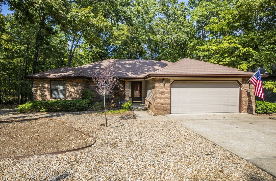 Great home in Bella Vista, Bentonville Schools. New wood style flooring throughout Main living area and bedrooms, tile in kitchen. 2 bed rooms and 2 full baths plus an office. Gas fireplace in living room. Awesome deck overlooking wooded area behind back yard. Low maintenance yard. Refrigerator included.