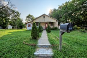 Adorable craftsman style charmer with original wood floors throughout part of the home. Updated flooring and bathroom in the master suite, clean white kitchen through the original arched doorways that leads to a good sized laundry room. Extra storage room on the back of the house that could be converted back into a porch if desired. The 2 guest rooms have original wood flooring and share a large bathroom with double sinks. Sits on a large corner lot with a detached garage near the campus, shopping, and restaurants!