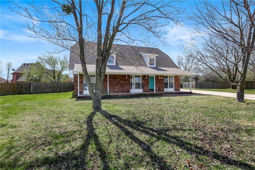 Looking for a large home with a large lot? Here it is.Conveniently located to UA and everything NW Ark. Three Bedrooms each with an updated full bath.4th bedroom is a large room that could be used will many purposes. Unique floorplan,3 window seats, a cool catwalk that overlooks the living area.The upstairs features real wood floors, dormers, skylights and large closets.Freshly painted Country kitchen ,pantry with adjoining laundry and half bath. Oversized side entry garage perfect for storage and a workbench. Charming covered front porch and covered patio are outdoor elements for your enjoyment.
Fenced huge backyard for family activities, Garden, and maybe a future pool. The new 10x12 storage building conveys.