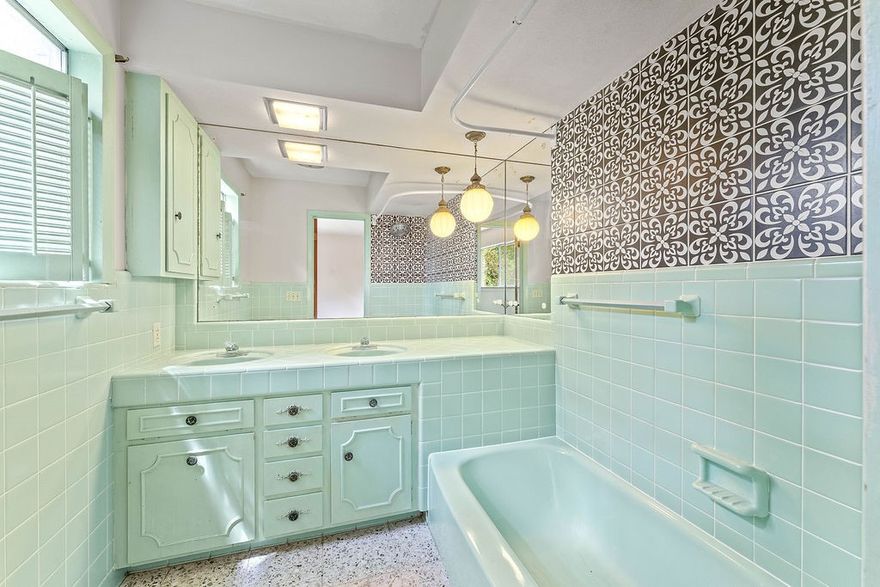 MOTIVATED SELLER! Charming mid-century home built by well-known builder Sandy Boone! This 1960's gem features an original colored tiled kitchen and bathrooms with matching tubs, plus unique custom stained glass light fixtures in the dining room, bathrooms, and even outside. Timeless character throughout with vintage touches you won't see in a new build. Prime location just minutes from Tyson home office, schools, and shopping on corner lot. Washer, dryer, and refrigerator convey. Fresh paint, new roof cleaned carpets, and pretreated pressure wash to exterior.