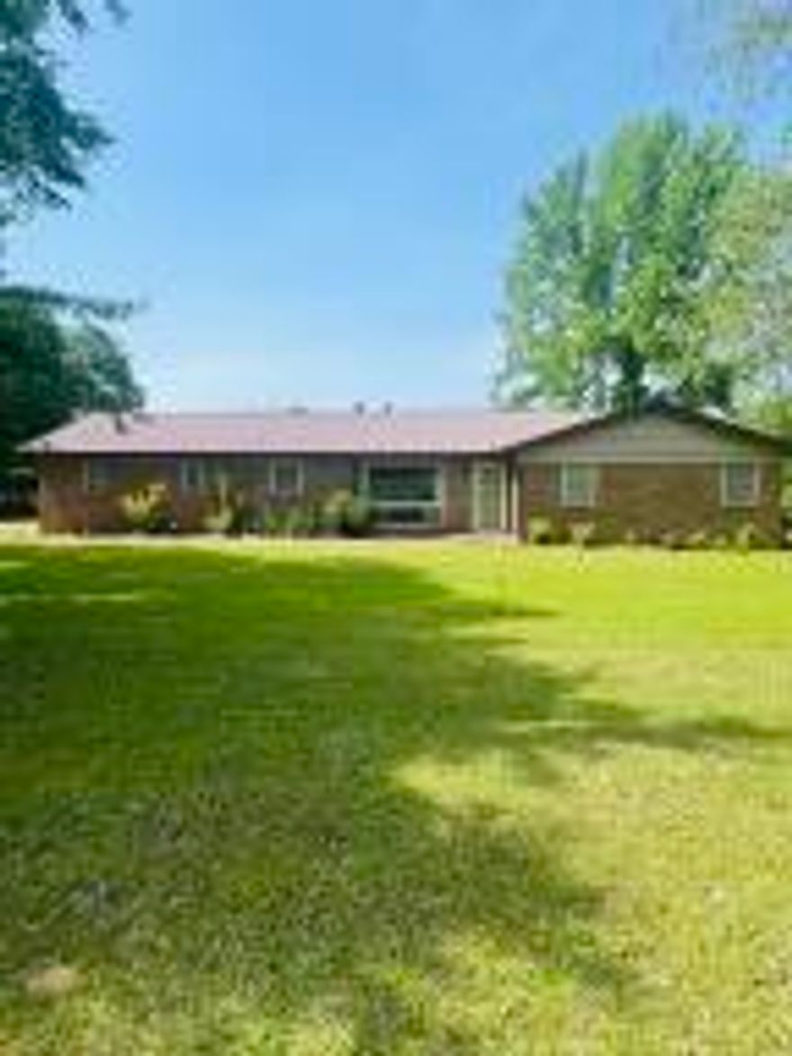 Looking for a house with big yard  and only a few minutes from the city? This  brick house has 1,496 living space,  offers 1.30 acres, huge covered patio, a tornado storm shelter, 3 bedroom and 2 bath. Also offers carport, fenced area for dogs, open floor plan and wood burning fire place.