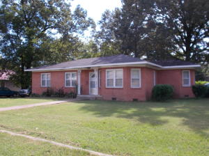 HIS BEAUTIFUL 1,800 sq. ft. BRICK HOME WON'T LAST LONG!! BRAND NEW ROOF AND NEW CHA! This 4 bedroom 2 bath home sits on a great corner lot with a large backyard and gorgeous trees. You won't be short on storage space because this home has tons of storage spaces and all 4 bedrooms have built-ins in the closets! LARGE kitchen with double oven, dishwasher, disposal, electric cook top, and lots of cabinets. Spacious breakfast/dining area with lots of windows. Ceiling fan light fixtures throughout the house are a plus! New tile flooring in the kitchen and carpet in living room and bedrooms that has original hardwood under carpet. Out building for additional storage or even a workshop! Fenced dog kennel behind outbuilding that is shaded. This is a must see home! Call for showing