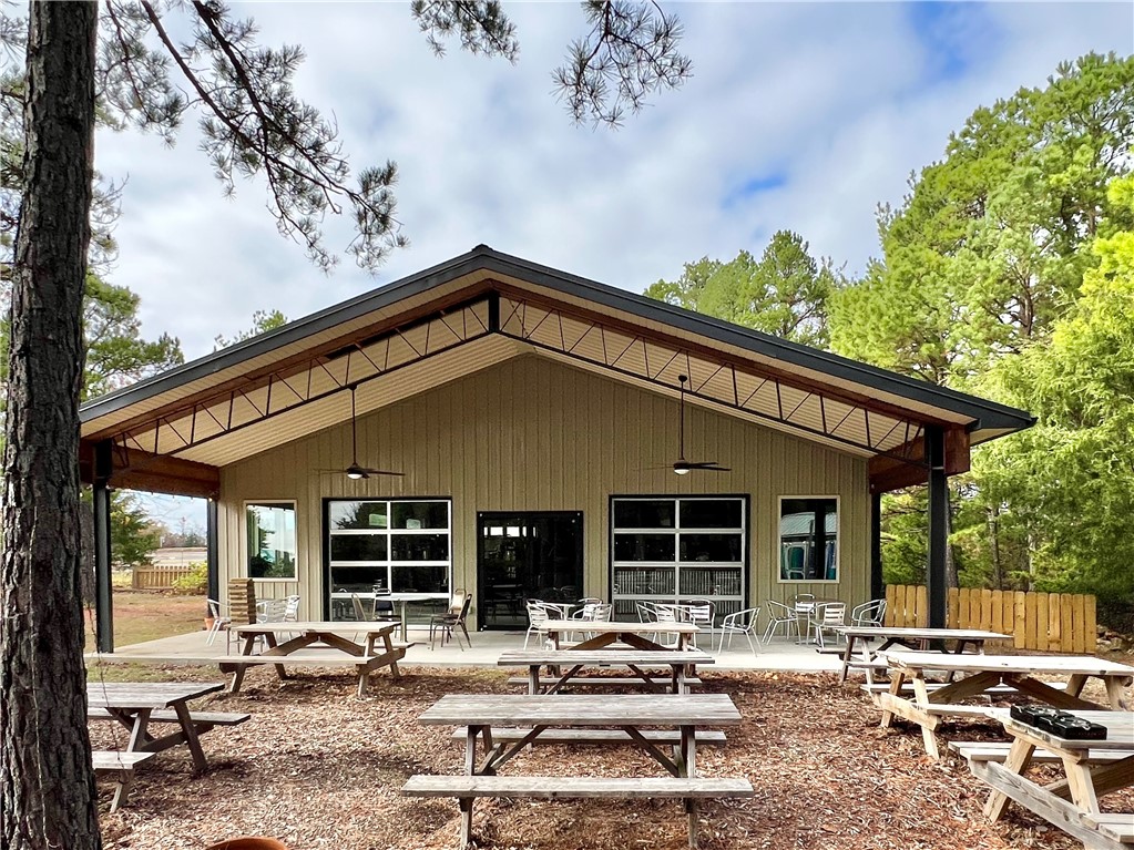 Award winning Brewery for sale in Eureka Springs. The current sellers have built a nice foundation for the Eureka Springs Brewery and its new owners to slide right in and seamlessly take over this small hometown, custom batch brewery. All brewing equipment as well as all fixtures and furniture will convey with the purchase. All local and state licenses and permits will be up to the buyers to obtain. The 2000 sq ft building sits on a lovely wooded +/- 3.2 acre parcel that sits just off the main thoroughfare. There is lots of natural light in this structure with several large picture windows and also from the 2 huge glass garage doors that open out onto the 12x40 ft covered patio. The Barndominium is only 6 years old and has a Monolithic foundation, high grade R29 insulation, standing seam, copper colored metal roof, with 3 phase electric on site, 1,500 gallon cistern, and a state licensed detached Exterior kitchen with grill cage. There are so many possibilities with this commercially zoned property.