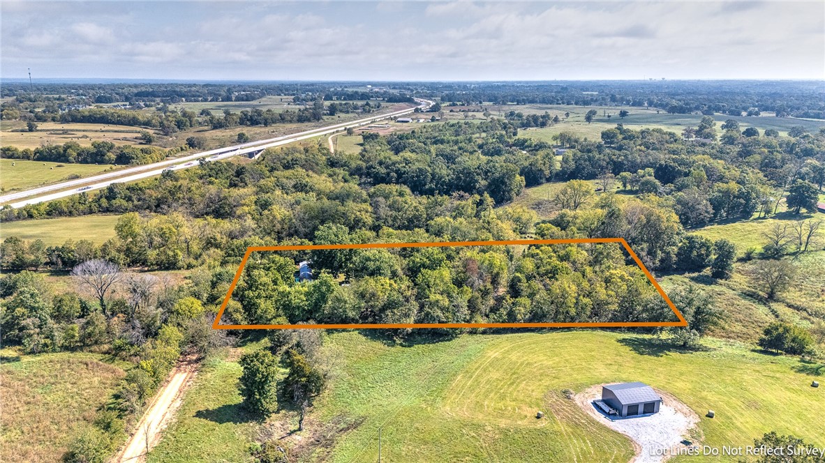 2.87 Acres Inside Gravette City Limits - Rare In-Town Acreage with Utilities & Build Potential
Welcome to your blank canvas just minutes from Gravetteās heart! This 2.87-acre parcel lies inside city limits, with electric already onsite, city water access at the road, fiber internet availability, plus an existing well & pond. The property features a 3-bed, 2-bath manufactured home (sold as-is, not on permanent foundation), a septic system likely needing replacement, and remnants of old foundations suggest multiple possible building sites. Gentle terrain, partial woodland, and open space offer flexibility for homesteads, small builds, or phased development. Located for convenience, a short drive to Gravetteās amenities (parks, trails, splash park) and easy access to regional hubs in Northwest Arkansas.