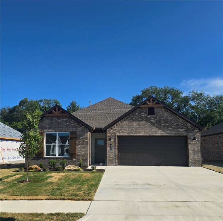 Welcome to Heritage Ranch, Phase 4! This brand-new home features three spacious bedrooms and two bathrooms. The open kitchen seamlessly flows into the dining and living areas, creating a perfect space for entertaining. Enjoy the vaulted ceiling and cozy fireplace with a mantle, which add warmth and character to the home.
Stylish finishes and amenities include brick and Hardie siding, cedar shutters, full guttering, LED disk lighting with fan and light kits in all bedrooms and more! The kitchen is equipped with a large island adorned with pendant lights and 3cm granite countertops. Additionally, a smart thermostat and a Frigidaire Gallery appliance package enhance both convenience and modern living.
This home beautifully combines style and comfort. It is conveniently located near schools and shopping, with easy access to everything Northwest Arkansas has to offer!