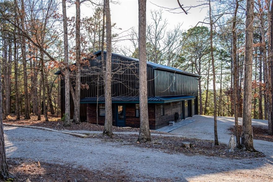 Modern 2023 construction on private 1.3-acre wooded lot 5 minutes from downtown Eureka Springs. This unique property features a primary suite with two walk-in closets, 2 full baths, an open loft with closet ideal for a second sleeping area or office, and a main-level bonus room off the garage suitable for guest space, office, or gym. Modern finishes include quartz countertops, tile floors, and a freestanding tub. Large garage adds flexibility. Commercial zoning allows nightly rental or multi-use. Some finishing details remain for custom options.