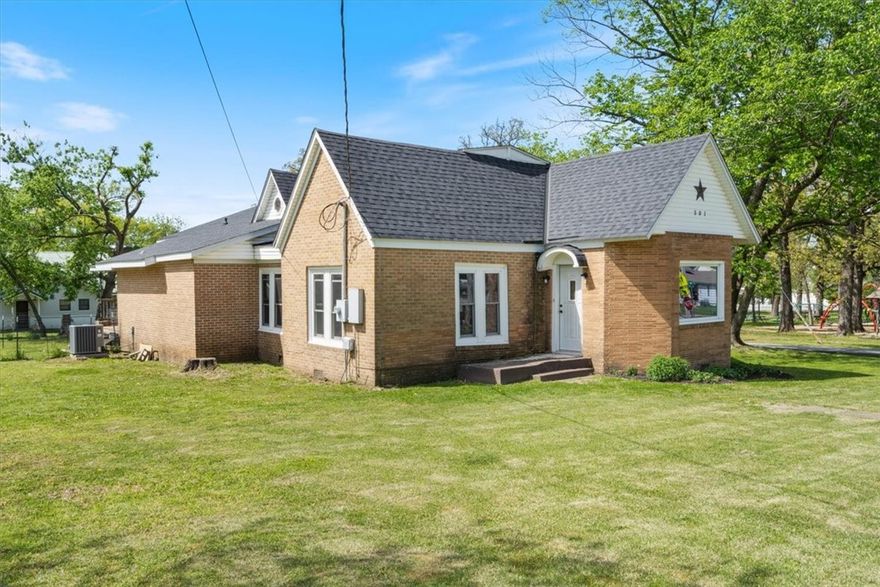 USDA ELIGIBLE!!! Charming potential in the heart of Gravette!  Set on a beautiful corner lot right across from “The Airplane Park” (Field Kindley Memorial Park), this home offers a blend of vintage character and thoughtful updates—ready for your personal touch.

Inside, you'll find a spacious living room filled with natural light, a dedicated home office, and brand new carpet throughout. The windows are all brand new and energy-efficient, bringing a fresh, bright feel to every room. A less than 3-year-old roof adds to the list of improvements.

Step out back to enjoy a covered patio, ideal for quiet mornings or casual evenings, surrounded by a generous yard space full of potential.

Enjoy the convenience of being just minutes from parks, restaurants, schools, and shopping, with quick access to the interstate only 10 minutes away.

Whether you're looking to invest or create a space that’s uniquely yours, this home is full of charm and opportunity.