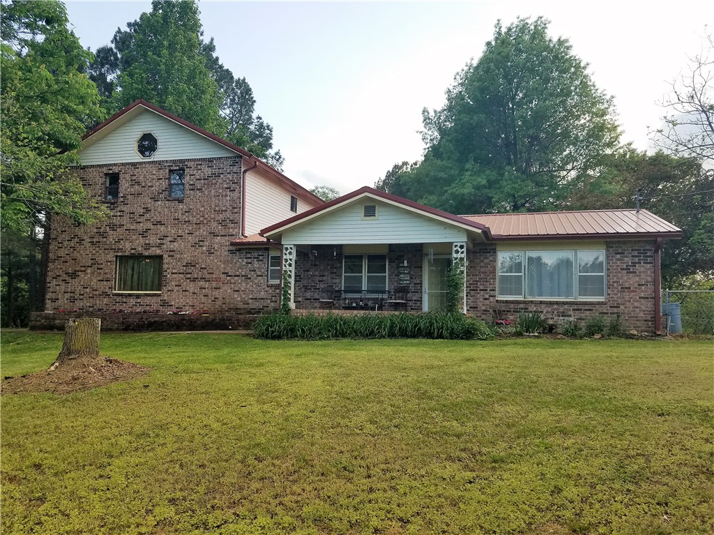 Serenity in the country with this superb split level. Numerous varieties of trees, curving driveway lined with pines & abundant redbuds & dogwoods. The living area will take your breath away, stairway is stunning wood which also wraps around the perimeter of the sitting area upstairs, the former owner reportedly was a music teacher and played his musical instruments here. You will love the spacious kitchen, freshly painted, new built-in microwave. Kitchen & adjacent dining room have natural stone floors.