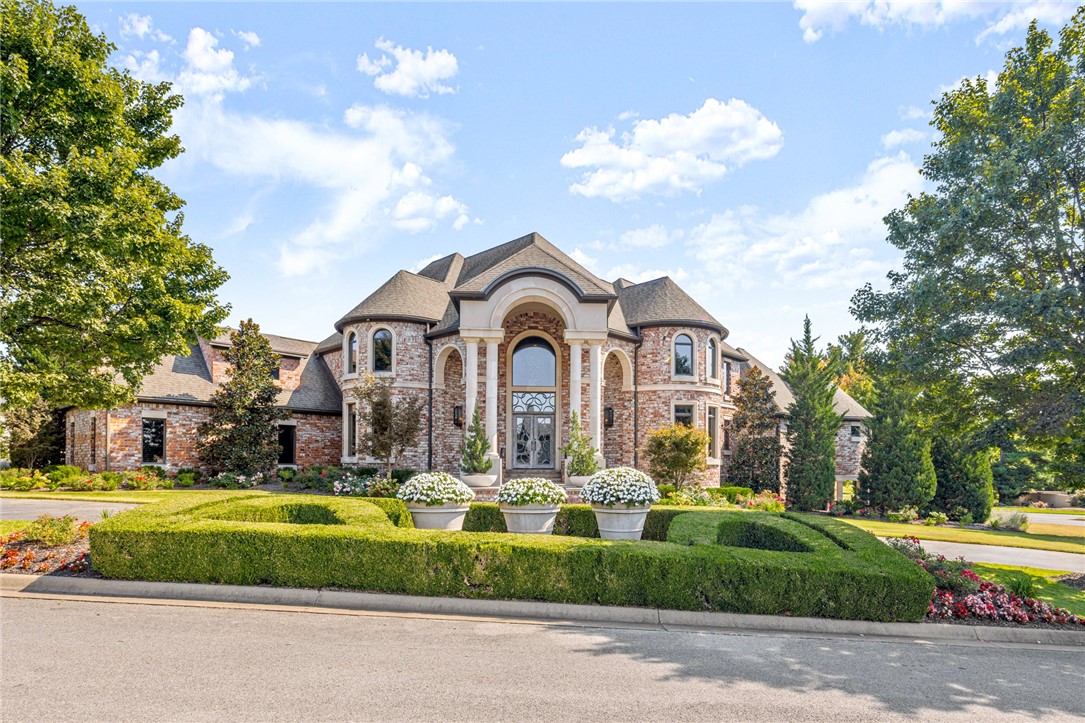 Contemporary Luxury Estate nestled on a corner lot in Pinnacle Country Club featuring an impressive, grand foyer w/ spiral staircase w/ floor to ceiling windows showcasing gorgeous views. The formal dining, custom-designed kitchen w/ large island offering pantry storage built- in, cabinets galore, eat-in dining area w/ double-sided fireplace adjoining the expansive family room & opening to the outdoor, cabana style patio & kitchen, are all perfect for entertaining. The private master retreat is truly an oasis w/ dome ceiling, double-sided fireplace, dreamy master bath w/ soaking tub, walk-through shower, heated floors & designer closet attached to laundry room. Upstairs you will find 3 en- suite bdrms w/walk-in closets, library, gym, 2nd laundry, game room & outdoor seating area. Basement features private suite w/ its own bathroom & patio plus theatre room w/kitchenette. The entertainment continues out back w/ heated, gunite pool, hot tub & sports court. THE ULTIMATE DREAM HOME