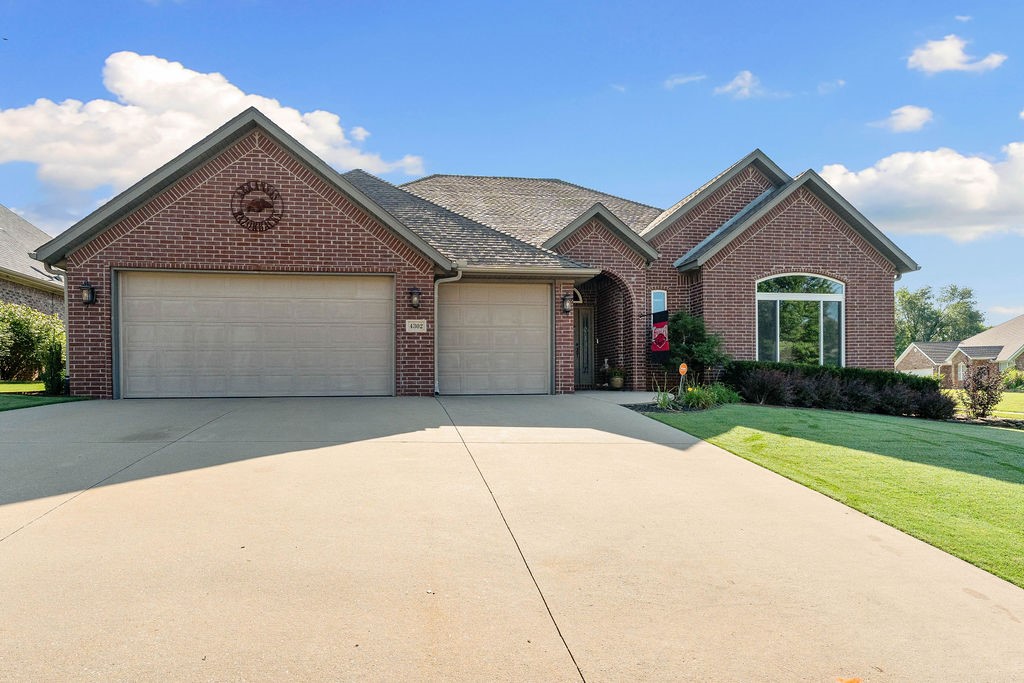 Impeccably maintained, one-owner, all-brick home in Kensington Subdivision—located just 2.5 miles from the Home Office. This spacious 1-level home features 4 bedrooms, 2.5 bathrooms & a rare 3-car garage. Inside is a large living room centered around a beautiful gas fireplace—perfect for relaxing or entertaining. The dedicated formal dining room offers plenty of space for gatherings, while the eat-in kitchen has SS appliances, ample cabinet storage & casual dining space. Enjoy seamless indoor-outdoor living with 3 separate access points to the back patio from the kitchen, dining room & primary suite. Primary bedroom features an ensuite bath with dual vanity, fully tiled walk-in shower & 2 spacious walk-in closets. Layouts include a split floor plan for privacy with 3 bedrooms on other side of the house. Home is smoke-free, pet-free. Many updates include roof, hot water heater, HVAC, windows & more. Don't miss this prime location with quick access to trails, schools, dining & Bentonville’s growing amenities.