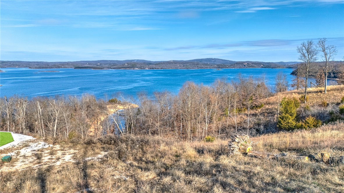 Discover the perfect canvas for your dream home on this extraordinary double lot, offering sweeping, unobstructed views of Beaver Lake. Nestled in the prestigious Cotswold Community, this prime piece of land provides the rare opportunity to build your ideal lake retreat in one of the most sought-after neighborhoods in the area. With its elevated position, this lot boasts panoramic vistas of the tranquil waters and surrounding natural beauty, ensuring that every sunrise and sunset will be nothing short of breathtaking. The quiet, serene environment offers both privacy and a sense of community. As a bonus, the property behind the lot adds extra privacy as it will not be built on. Also, features a boat slip in a 4-slip community dock, providing you direct access to Beaver Lake for boating, fishing, and all your favorite water activities. Whether you're looking to build a luxurious lakefront estate or a cozy getaway, this lot offers endless possibilities. Donāt miss this oneāschedule a showing today!