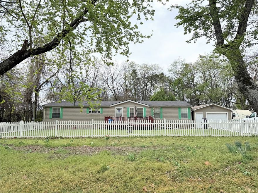 Welcome home to this beautiful and spacious 3-bedroom, 2-bath manufactured home featuring a desirable split floor plan. Inside, you’ll find cozy living spaces with a wood-burning fireplace, walk-in closets, and plenty of room to spread out. Step outside to enjoy the large front deck or relax on the screened-in back porch, perfect for quiet mornings or evening gatherings. The property is shaded by mature trees and offers great outdoor features including a storm shelter, detached one-car garage, and a handy work shed. With a new roof installed in 2021, this one check all the boxes!