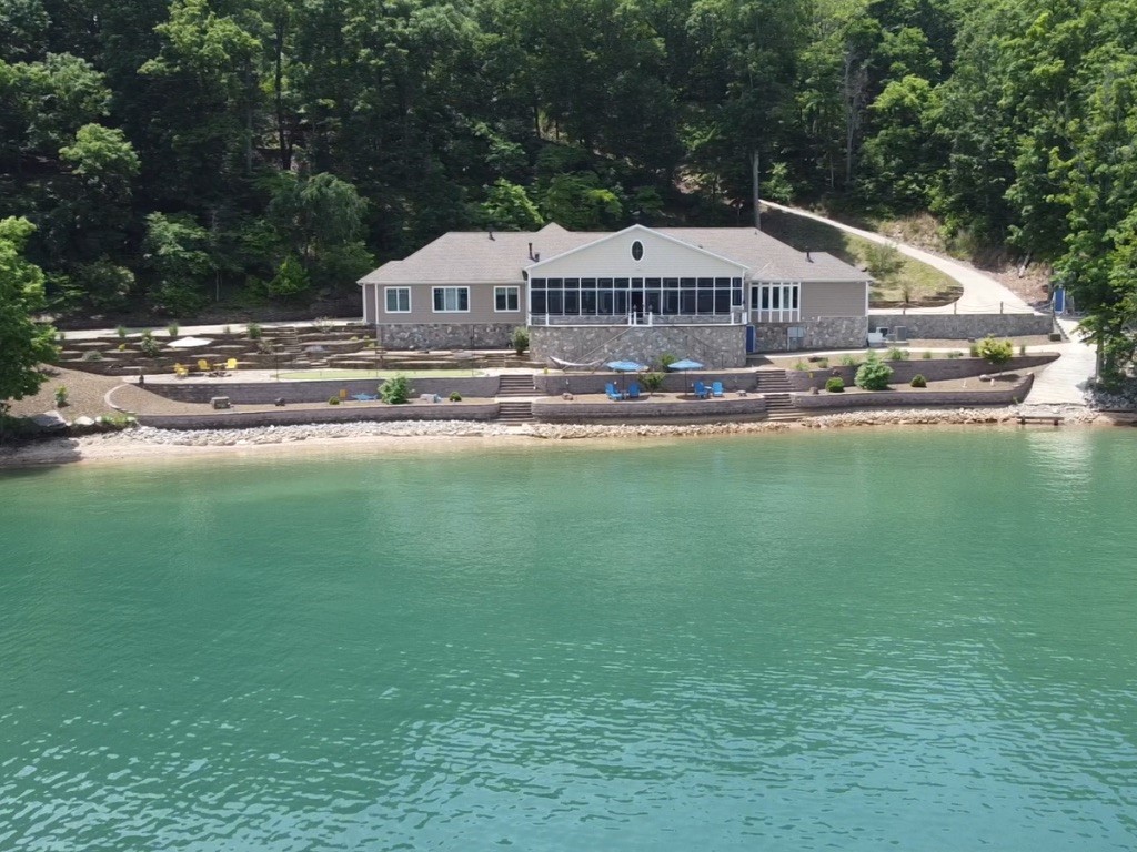 Rare opportunity to own a custom built waterfront home on Beaver lake on 3.62 acres with easy access to the water. Included is an additional 5.21 acre buildable lot with a newly refinished private boat dock. Features include a concrete reinforced 700+ bottle climate controlled wine cellar / safe room. a large John Deere storage room, custom lighting and ironwork, Large Walk in pantry. The second bedroom doubles as an office with built in Murphy bed. The Owners suite offers a spa like experience with heated floors and walk in shower. Oversized two car garage with shop and storage room. Enjoy the whole house automation and entertain in large screened in galley and living area. The property boasts a professionally landscaped low maintenance yard that include bocce ball court, fire pit and breathtaking views. Additional 5.21 acres Parcel #18-00239-001
