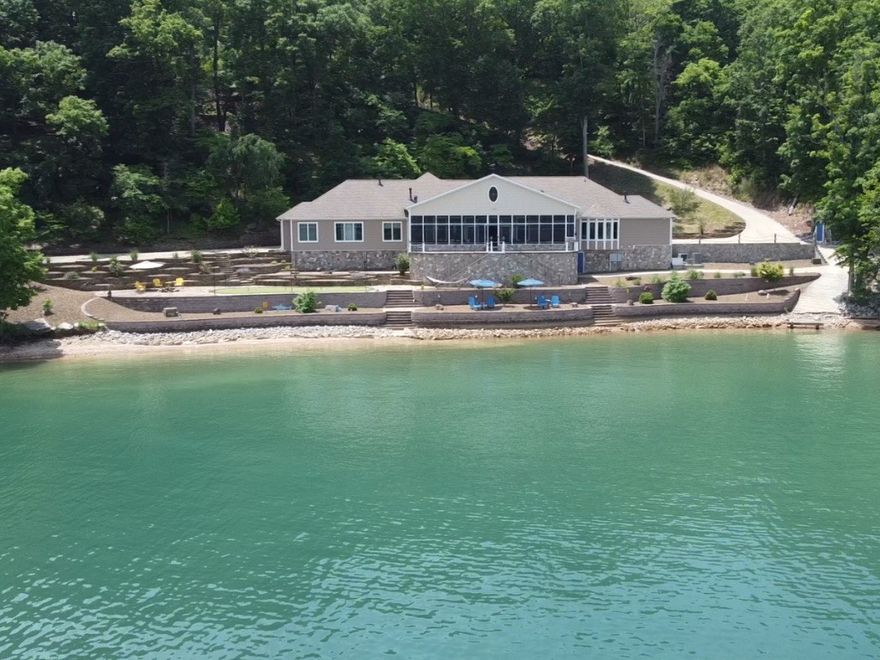 Rare opportunity to own a custom built waterfront home on Beaver lake on 3.62 acres with easy access to the water. Included is an additional 5.21 acre buildable lot with a newly refinished private boat dock. Features include a concrete reinforced 700+ bottle climate controlled wine cellar / safe room. a large John Deere storage room, custom lighting and ironwork, Large Walk in pantry. The second bedroom doubles as an office with built in Murphy bed. The Owners suite offers a spa like experience with heated floors and walk in shower. Oversized two car garage with shop and storage room. Enjoy the whole house automation and entertain in large screened in galley and living area. The property boasts a professionally landscaped low maintenance yard that include bocce ball court, fire pit and breathtaking views.       Additional 5.21 acres Parcel #18-00239-001