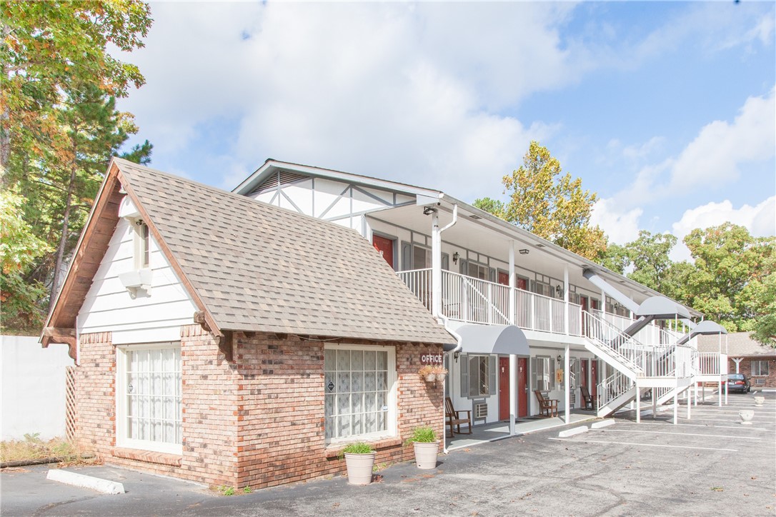 Bankruptcy overbid opportunity. Location. Location. Location. Turnkey, well-established 24-unit hotel which sits off the main highway, mere seconds by car from downtown Eureka Springs. This property has it all, a long-established history, ample parking, pool, 2 spa suites, a generous assortment rooms with both 1 and 2 beds, keyless entry to all rooms, and a staircase which leads towards Main Street and thence to downtown Eureka Springs. There is an undeveloped, approximately 1/4-acre flat area on property which could potentially accommodate additional units, RV space rental, or be built to fit your own vision. Perfect for an owner-operator or as an addition to your existing leisure property portfolio.