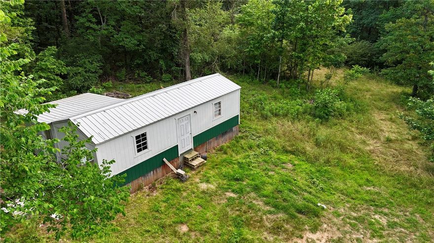 Tucked away in the peaceful countryside, this 1-acre lot offers privacy, potential, and a rustic start to your dream retreat. The main 16' x 40' structure includes a studded 12' x 12' addition—perfect for customizing into your ideal getaway. Electric and water are already on site. With a little vision and effort, this property is ready to be transformed. Sold as is—bring your imagination and make it your own!