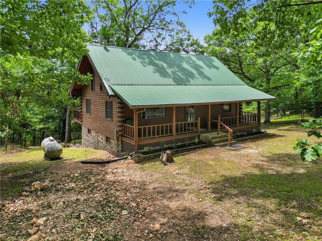 10x30 BOAT SLIP included w/this renovated Beaver Lake area log cabin! Located near Starkey Marina, the White River/Beaver Dam & only 10 miles to downtown Eureka Springs! Open concept great room, w/soaring ceilings, features an all new kitchen, refinished wood floors, cozy wood stove & access to the covered deck. Remainder of the main level consists of powder room & primary bedroom w/2 closets & spacious bath! The loft could be an office, reading room or extra sleeping space. Brand new 3-zone HVAC system for comfort & efficiency! Walk-out lower level features 2 more bedrooms, family room, full bath & laundry area. Situated on a quiet, paved street in the Lake Forest neighborhood, this home would be a wonderful permanent residence, vacation home or investment property. Short-term rentals allowed...Eureka area log cabins are popular all year long! Recreational opportunities abound w/nearby ziplining, fishing, hiking & mtn biking! Come enjoy the charm & allure of lake life! Also listed as MLS #1295788.