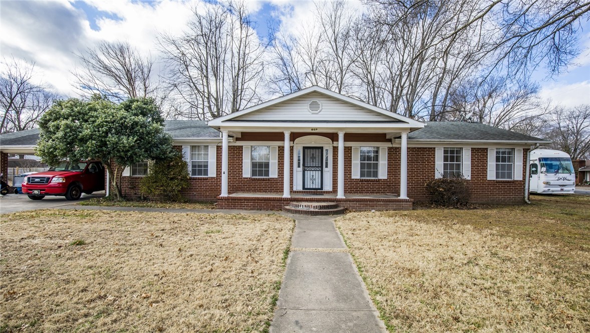 Great home within walking distance to Downtown Bentonville. This 3 bedroom 2 bath home features large lot with fenced yard, living room, formal dining and eat in kitchen, family room and enclosed porch. New laminate wood flooring throughout and fresh paint. Lots of storage. Storage shed included.