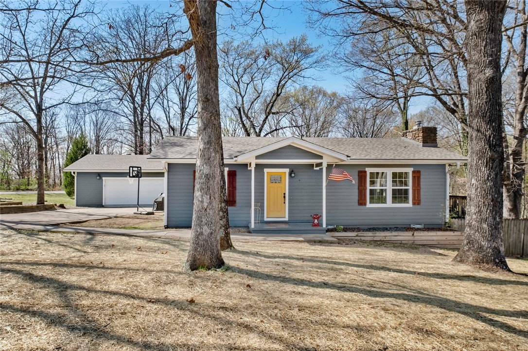 ACROSS FROM FLO RIDE TRAIL! - What was once a 2 bed 1 bath carport home has been converted into a 4-bedroom 2 bath 2 car garage on a large corner lot surrounded by common property on both sides. 2018 Updates include Hardie Plank siding, gutters, windows, large primary bed/bath with soaking tub and French doors to view nature or access the wrap-around porch, 800 SF garage with insulated overhead door to store all your toys, oversized driveway for ample parking, updated kitchen includes custom solid hickory wood cabinets, 3cm granite counters, dishwasher, microwave, with an even newer range replaced in 2025. 2x6 exterior walls on the original portion of the house with electric bills rarely above $200 per month. New 30-year roof in 2019. New septic tank installed 2025.