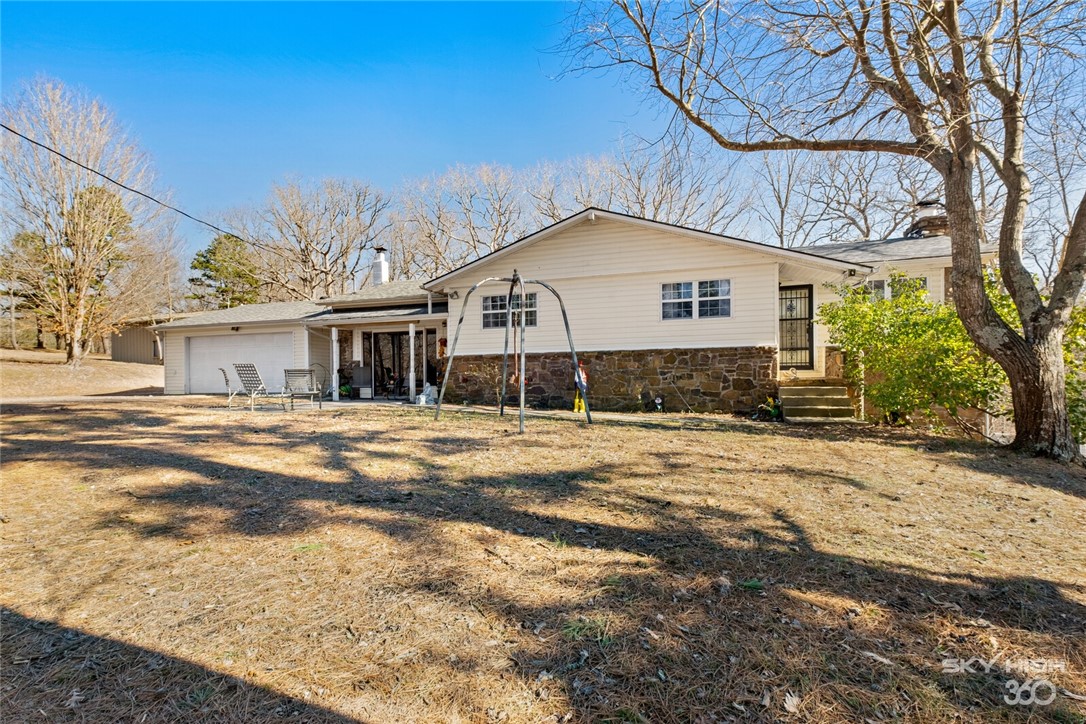 Ever imagined having your own forest dirt trail in your back yard with a quick drive to XNA? This property is for you! 3 bedroom 2 bath home sits on 25 acres. Seller is installing a new dishwasher, finishing stairs and finishing floors in the basement rooms. New central heat/air. Roof replaced in 2018. 30x50 shop with full electric. The land offers income potential with a 16x40 tiny home with full utilities, 14x65 single wide trailer with full utilities and full RV pad with hookup all on a second septic system. There is a spring fed pond and creek on the property. Building on the south part of the property will not convey.