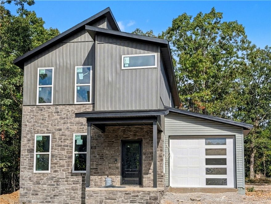 Welcome To Your Next Home! This Beautiful New Construction In Bella Vista Is The Perfect Blend Of Modern Design And Everyday Function. The Main Level Features 9-Foot Ceilings And An Open Living Area That Flows Effortlessly Into The Kitchen. The Cozy Fireplace With Detailed Trimwork Becomes The Focal Point Of The Living Room, Creating A Warm And Inviting Atmosphere. The Kitchen Is Equipped With Custom Cabinets And 3CM Granite Countertops, Making It A Space Designed For Both Style And Function. The Dining Area And A Convenient Half Bath Complete The First Floor. Upstairs, Also Featuring 9 Foot Ceilings, The Primary Suite Offers A Spacious Retreat With A Dual Vanity And A Full Custom Tile Shower In The En-Suite Bath. Two Additional Bedrooms, A Full Hall Bath, And A Laundry Area Complete The Upper Level. Outside, The Back Patio Leads To A Flat, Usable Backyard—Ideal For Outdoor Enjoyment. Branchwood Rec Center And Trails Close By. This Home Has Everything You Need—Come See It Today!