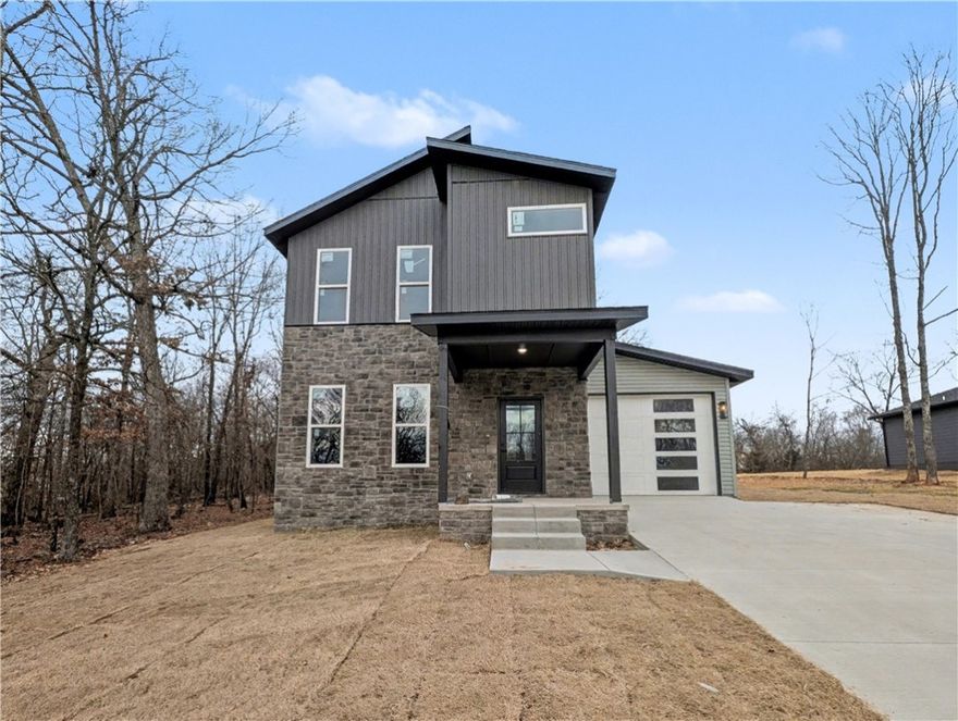 Welcome To Your Next Home! This Beautiful New Construction In Bella Vista Is The Perfect Blend Of Modern Design And Everyday Function. The Main Level Features 9-Foot Ceilings And An Open Living Area That Flows Effortlessly Into The Kitchen. The Cozy Fireplace With Detailed Trimwork Becomes The Focal Point Of The Living Room, Creating A Warm And Inviting Atmosphere. The Kitchen Is Equipped With Custom Cabinets And 3CM Granite Countertops, Making It A Space Designed For Both Style And Function. The Dining Area And A Convenient Half Bath Complete The First Floor. Upstairs, Also Featuring 9 Foot Ceilings, The Primary Suite Offers A Spacious Retreat With A Dual Vanity And A Full Custom Tile Shower In The En-Suite Bath. Two Additional Bedrooms, A Full Hall Bath, And A Laundry Area Complete The Upper Level. Outside, The Back Patio Leads To A Flat, Usable Backyard—Ideal For Outdoor Enjoyment. Branchwood Rec Center And Trails Close By. This Home Has Everything You Need—Come See It Today!