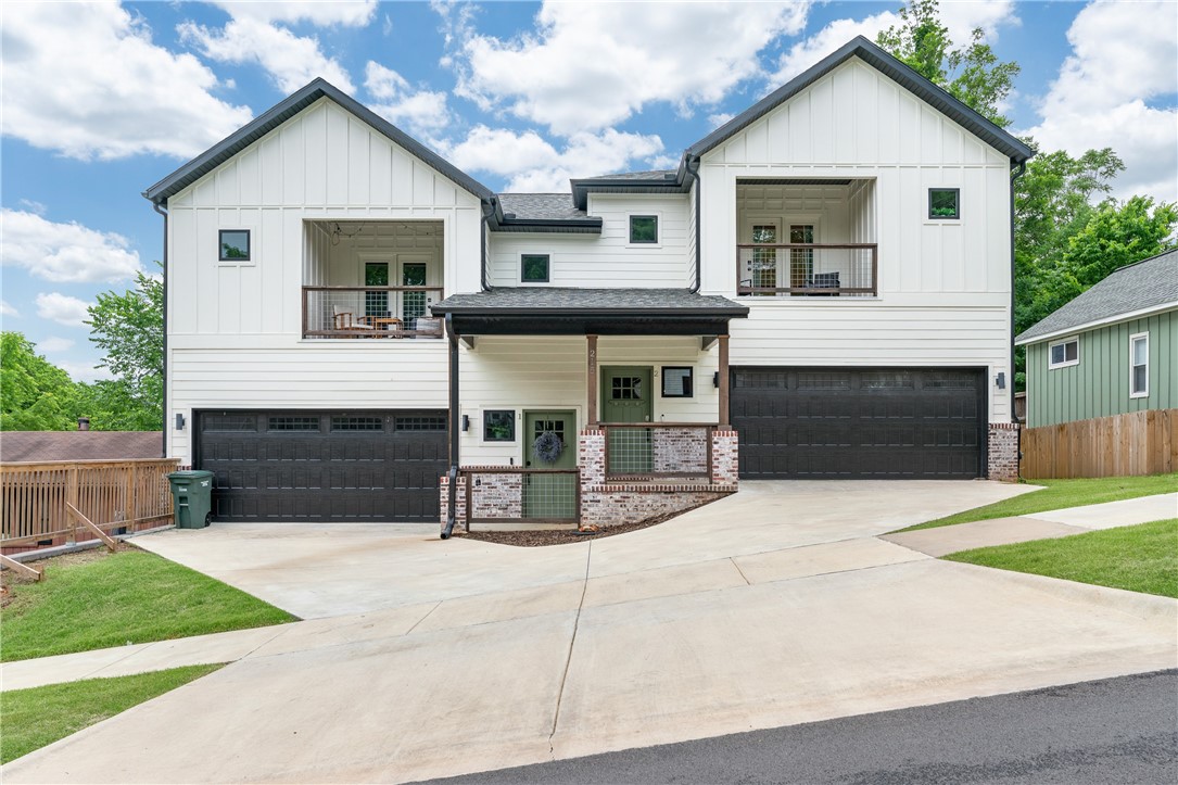Nestled in the heart of downtown Fayetteville, this stunning duplex presents a unique opportunity to own a modern, income-generating property in one of the city’s most desirable locations. Each unit features 3 bedrooms and 2.5 bathrooms with open-concept layouts, granite countertops, high ceilings, walk-in closets, and private covered balconies ideal for relaxing or entertaining. Whether you're an investor seeking premium rental income or a buyer looking to live in one unit while leasing the other, this property offers flexibility and long-term value. Enjoy walkable access to the University of Arkansas, the cultural experiences of the Walton Arts Center and TheatreSquared, the buzz of Dickson Street, and the community charm of the Fayetteville Farmers Market. With its stylish finishes and unbeatable location, this property is a standout opportunity in the downtown core.