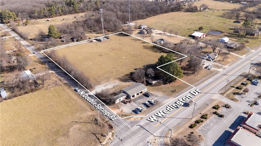 Prime location as growth is expanding west on Wedington Dr. Property is located at the northeast corner of W Wedington Dr & N Double Springs Rd. At a 4-way lighted intersection. Less than 10 minutes to I-49 access. Value is in the land, buildings on property sold AS-IS.

3 parcels totaling 6.23 acres.
373' of frontage on W Wedington Dr.
16,000 CPD that will continue to grow.
Water & Sewer at street.
