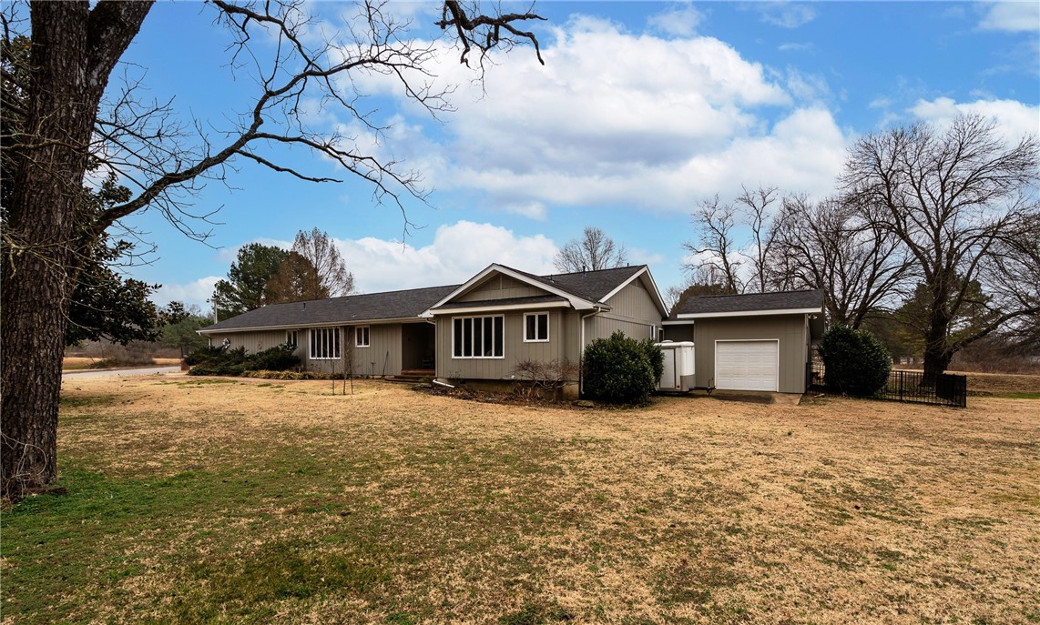 Very nice well maintained home located in a subdivision but still secluded! Large bedrooms each with it's own bath, spacious open living area with built ins, gas log/wood burning fireplace. Wonderful outdoor living space for entertaining. Over sized garage - 24 x 30 with lots of storage space. A 14 x 20 storage/workshop area that has concrete flooring, storage and electric. HVAC replaced in 2013, Roof 2014, Built-Ins in living room 2014, completely updated full bath off kitchen 2015. New gas logs for fireplace 2016, painted kitchen cabinets 2016 and new exterior paint 2019. Home is in the flood plain and will require flood insurance. Please see disclosure regarding flood plain.