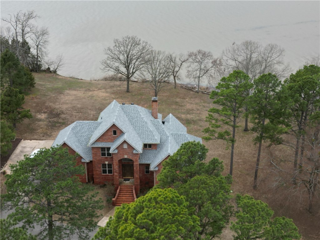 Discover unparalleled luxury in this custom-built 4-bedroom, 3-bathroom home nestled on two pristine acres along the Arkansas River. The cathedral-ceilinged living room boasts expansive windows, offering breathtaking river vistas and an abundance of natural light. Throughout the home, granite countertops add a touch of elegance, complementing the high-end finishes.The stunning primary suite serves as a private sanctuary, featuring a luxurious ensuite bathroom equipped with a jacuzzi tub and a spacious two-person shower, providing a spa-like retreat within your own home.Modern amenities include a brand-new roof installed in 2024 and a Generac home generator, ensuring comfort and security in all seasons. Each morning, enjoy the serene experience of deer visiting your property,