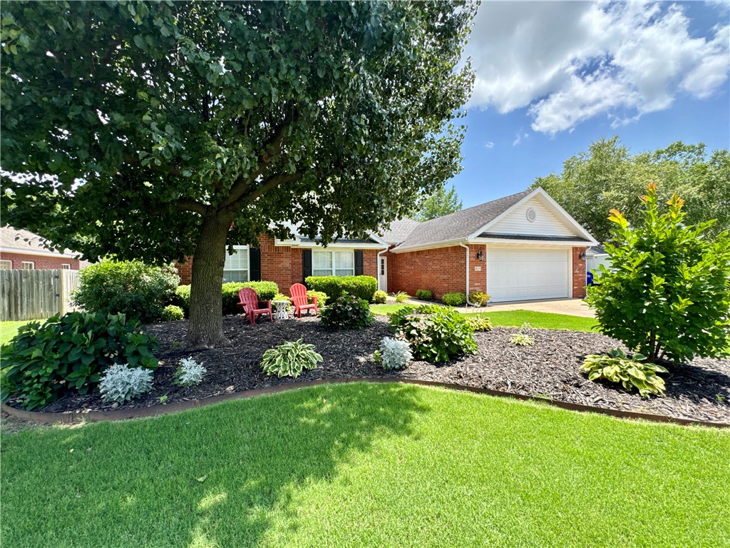 This charming 3-bedroom, all-brick home sits in a peaceful, private loop in NW Arkansas—perfect for quiet walks on the 1-mile neighborhood circle. Located in a desirable, established community near top-rated schools, parks, shopping, and dining, you’ll enjoy quick access to all that Bentonville, Rogers, and the Razorback Greenway have to offer. Step inside to a warm, inviting living space featuring a cozy fireplace framed by arched windows—ideal for morning coffee. A second living area offers flexible space for a home office, game room, or TV lounge. The open layout includes both formal and casual dining areas plus a kitchen bar for easy entertaining. Major updates include a new HVAC system and water heater (2022). The private backyard has no homes directly behind it—perfect for quiet evenings or play. Don't miss this opportunity to live in a peaceful neighborhood close to all the action NW Arkansas has to offer!