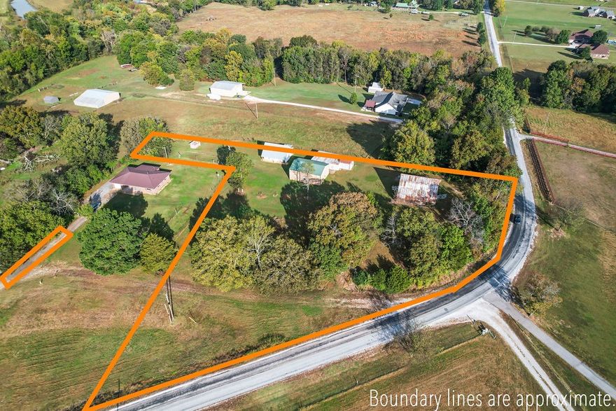 Beautiful acreage with tons of potential! Gorgeous setting with rolling hill views. Multiple outbuildings including barn and shop to handle any of your projects and all the storage one could need. Perfect location to build your dream home or renovate what is there. Shopping, dining and schools are moments away, with University of Arkansas about 15 minutes. Come check this one out today and see all the possibilities just waiting for you!