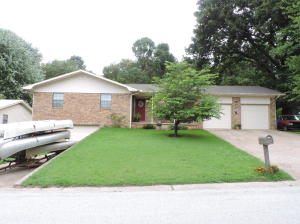 Nice three bedroom, brick and frame home in popular neighborhood in Harrison.Pretty kitchen cabinets, some with glassfronts. Double garage on main level. One car garage and large storage area in unfinished basement. New deck.Roof only7 yrs old. Storage room behind garage could be accessed through the utility room to add 2nd bathroom. Fenced yard. Garden spot with water tank. Greenhouse.