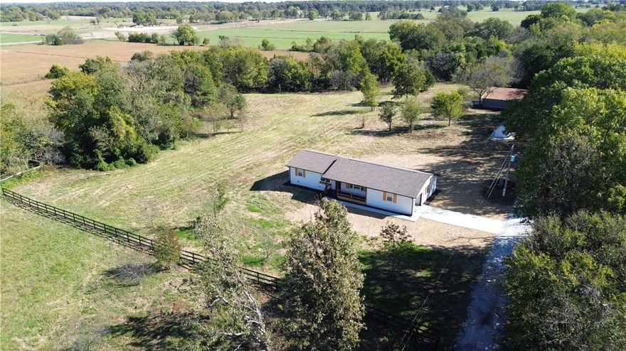Enjoy the perfect blend of comfort, space, and country charm with this beautifully remodeled home on 4 acres. Offering 1,840 square feet of living space, this 4br, 2br home is designed for both functionality and relaxed rural living. Step inside to a bright, open-concept layout that connects the kitchen and living room—ideal for family gatherings and entertaining. The home features a stylish mix of carpet, tile, and luxury vinyl plank flooring throughout.The kitchen offers ample cabinetry and workspace, while both full bathrooms have been tastefully upgraded with modern finishes.  Two laundry areas—one utility closet with washer/dryer connections and a separate utility room with additional hookups—add everyday convenience. The 4-acre setting provides plenty of room to roam, garden, or simply relax and enjoy the peaceful surroundings. A 1,500 sf metal building offers endless potential, complete with spray-foam insulation and large drive-in/out doors on both ends, perfect for a workshop, garage, or hobby space.  .