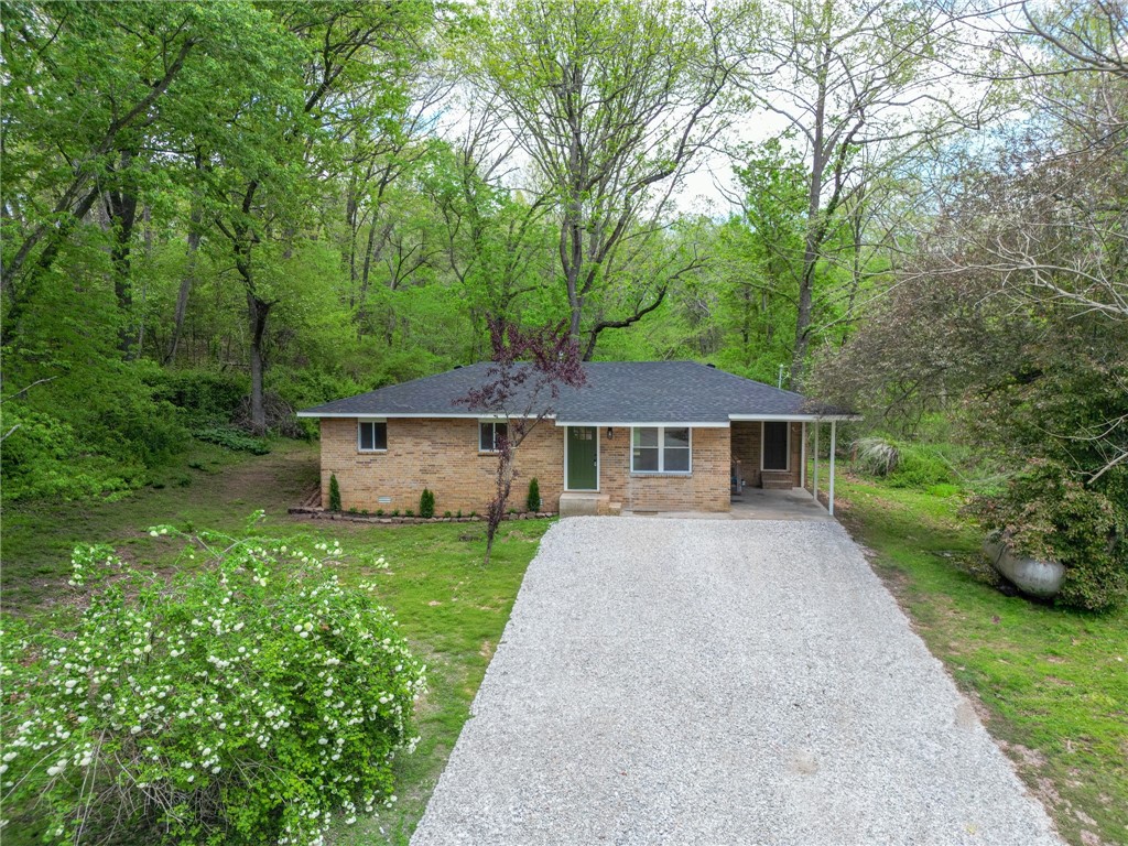 Like new and fully remodeled with all the newest touches—this one’s ready to go! With a brand-new roof, floors, fixtures, windows, bathroom, air conditioner and more, the heavy lifting is already done. Set on a spacious lot in Garfield, this property offers room to grow and a chance to enjoy country living with modern updates. Additional acreage available! Secluded feel with just minutes to downtown Rogers or Pea Ridge, plus there’s a natural spring close to the house!. A solid option whether you're looking to settle in or expand. This is the perfect find for someone looking to be centrally located and yet maintain privacy!