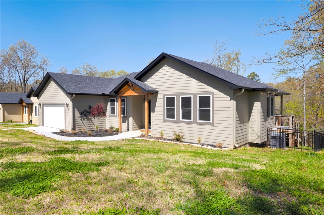 This adorable, move-in ready spot in south Bella Vista is situated just 7 miles from the Bentonville square, with easy access to all of Benton Countyās coolest spots! The pristine home features quality craftsmanship and wooded areas on two sides for max privacy, while the interior welcomes you into a serene, neutral color palette offering granite countertops, engineered hardwood flooring, a contemporary fireplace, spacious owner's bath with tiled shower, office/flex space, and covered deck overlooking greening treetops. Built in fall of 2022, itās truly better than new, as all the desirable yet costly upgrades on your wish list have been added: landscaping, premium iron fencing, gutters, cabinet hardware, and stunning black stainless steel appliances including an upgraded French door refrigerator. Just 3 mins to Starbucks and the trailheads, and located within the Bentonville school district. Ride out of your driveway, literally, and hit the trails! Pics truly don't do this home justice.