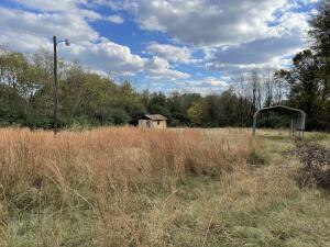 Are you looking for a piece of land ready to go? This 1.39 acres have the utilities on site. There is a concrete building and a single car portable carport. Ready for you to build your home.