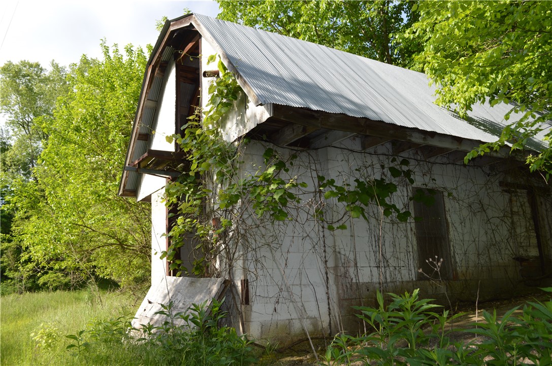 This is a very private property with many outbuildings but are in need of repair. The property is however a short drive off of paved Highway.