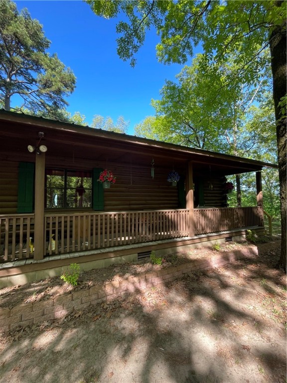 HUGE price reduction!!! This custom built REAL LOG house can be yours ! Energy efficient; three bedrooms and two full bathrooms; split floor plan. Covered porch on the front, with wrap-around deck on the back and side. Love the great outdoors with gorgeous views and crave privacy and tranquility? This is it! Enjoy a bountiful harvest from your four pear trees each Fall. LOTS of gardening spaces, but also lots of woods for hunting or hiking. You'll have it all in your own 20 acres. Don't miss the $1,000,000 view from the North side! No sounds of civilization, but only 10 minutes from town! The contractor constructed this beautiful house to be his forever home! Impeccable workmanship! Spacious, comfortable floor plan! Deep well with salt filtration system (new pump) Awesome water! Roof 6 years od. HVAC 7 years old. Water heater 2 years old. Generator and appliances convey with acceptable offer. Lightning rods to prevent damage to the home