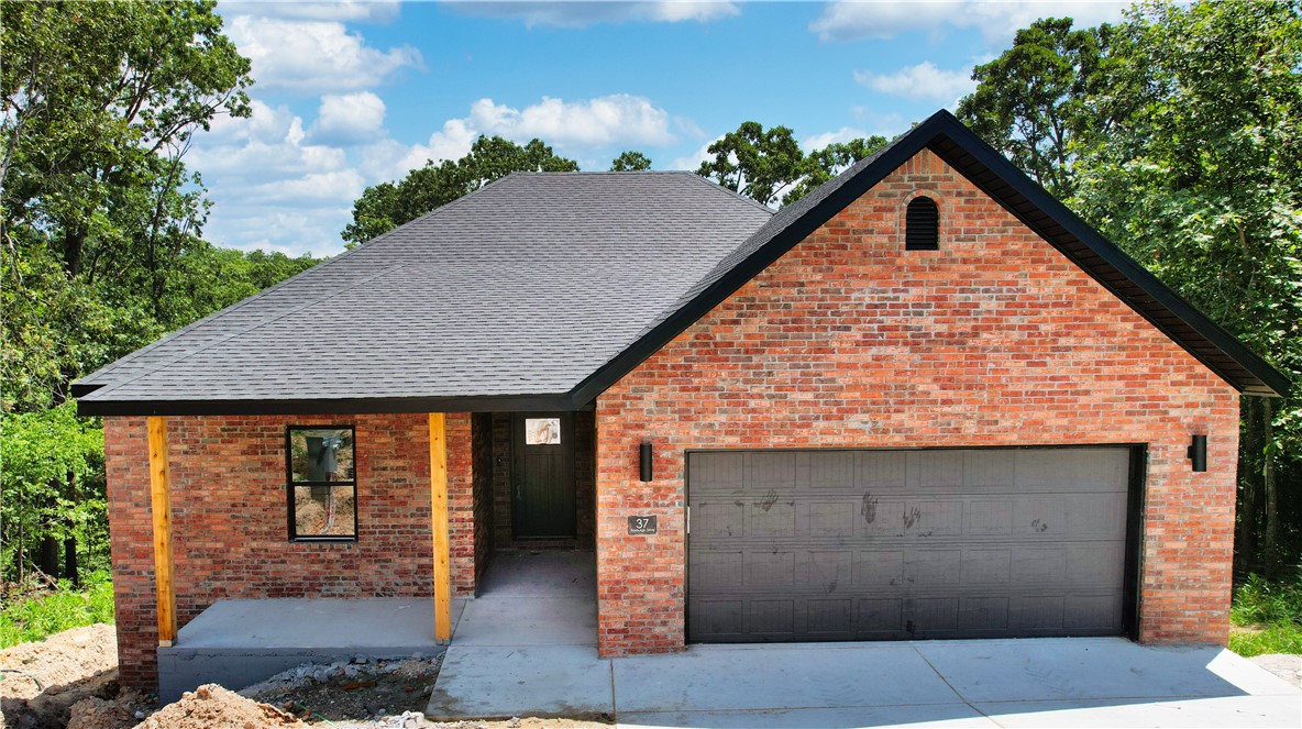 Tradition outside, a fresh take within—this newly built 3-bed/2-bath Bella Vista home blends timeless curb appeal & a bright, open interior designed to feel like home. Enjoy natural light throughout, a granite island, SS appliances, walk-in pantry & cozy dining nook. LVP flooring, curated lighting, laundry room & recirculating water heater boost everyday comfort. Step out to a covered porch & private backyard framed by trees—perfect for coffee or weekend gatherings. A 2-YEAR Builder’s Warranty brings peace of mind. Whether hosting or unwinding in Ozark serenity, this home moves with your rhythm. Minutes from Walmart Super Center, Scotsdale Golf Course & Branchwood Rec Center—perfectly positioned for active, fulfilling living. Interior photos from a similar home.