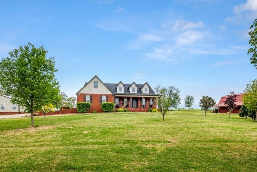 Home on 4.89 AC w/Barn & Guest House in Cave Springs! Gorgeous curb appeal w/ trees, rolling acreage & spacious drive up to home. Covered front porch welcomes you into the main house w/flowing layout, hardwood floors, 9ft ceilings & natural light. Living room w/built in window seats & gas fireplace. Formal dining space. Eat-in kitchen has granite counters & stainless appliances. Updated covered patio offers a relaxing & private outdoor living space. Primary suite on main level w/access to office/den space as well as large bath & WIC. 2 guest beds & a guest bath on main level as well. Upstairs is an additional workspace area w/built ins. Guest bed & bath along w/2 additional bonus rooms & plenty of storage.  Detached 1,280 SF guest house has open living area & kitchen,2 beds & a bathroom plus washer/dryer connection. Barn features garage door space & 2nd level storage. Roof in ‘22. Easy access to Pinnacle area shopping/dining/and entertainment & historic Cave Springs. Rare find for this amount of acreage!