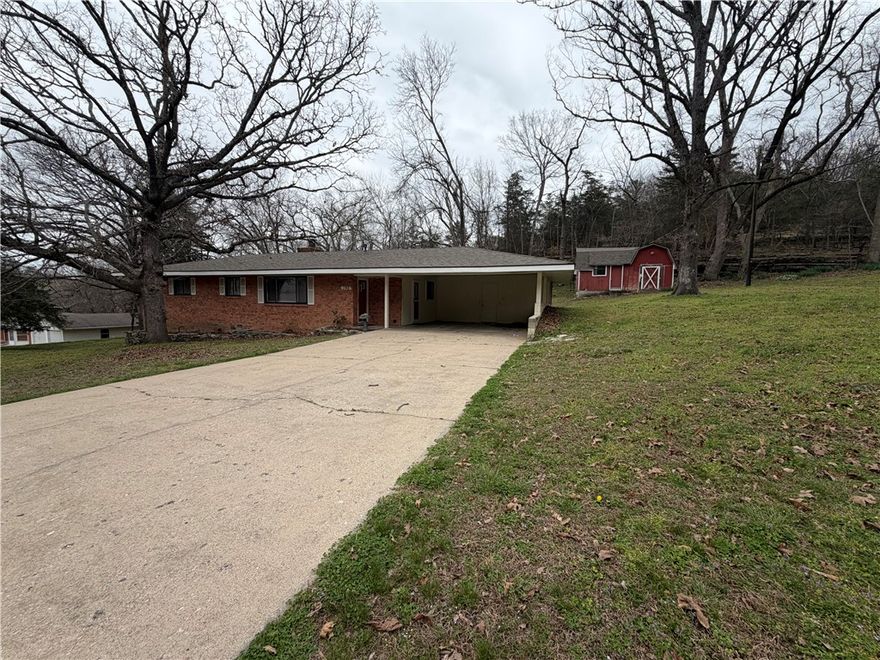 Beautiful setting with this 2 bed 2 bath home in Rogers just minutes from Beaver Lake.  Kitchen includes refrigerator, gas top range and built in oven and pantry.  Large living room with fireplace.  Home also includes an enclosed back porch.    Additionally included it a large storage shed.