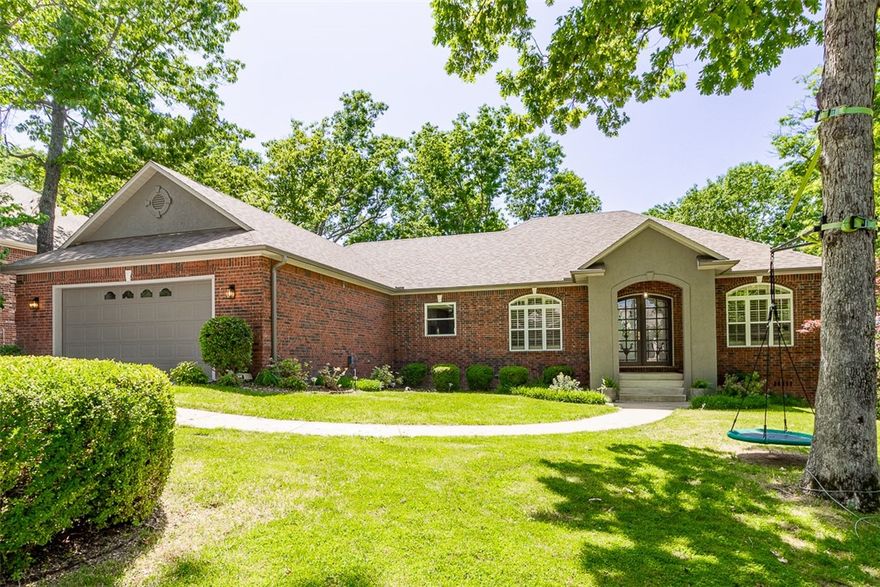 Live in the wooded beauty of the Hidden Springs neighborhood with easy access to I49, the bike trails  & Bentonville's vibrant town square.  Jump on your bike for an easy ride to the entertainment & dining in the square then on to Crystal Bridges to enjoy the art and beautiful grounds.  Your serene home offers an inviting primary suite which opens to a spacious bath with walk-in shower, double vanities, whirlpool tub, & large closet. The open floorplan allows the family room, formal dining (currently a play room), breakfast area, & kitchen to serve as one continuous family center. Two additional rooms & an  updated bath complete the main level.  This home has 2 water heaters for the best showers ever! You have two more rooms & a bath downstairs with access to the lower level covered deck & beautiful back yard.  Updates include new roof, fence ,deck, & HVAC for living area in  2024. Updated tile shower enclosure in hall bath, updated light fixtures, new sliding door, & new  windows in the family room.