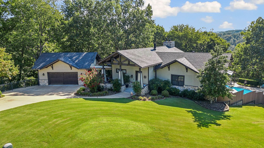 Very rare opportunity to own the architects personal home sitting on 1.38 acres with seasonal views of Lake Atalanta and close to Beaver Lake. Unique home with features like a heated, self cleaning pool with outdoor bathroom to whole house indoor and outdoor Sonos system. The heart of home is the kitchen with tons of granite with island, lots of cabinets, induction or gas range, double oven with warming drawer, walk-in pantry and dumbwaiter to downstairs. Dining area looks down on the living room with 25 foot soaring wood lined ceilings with a wall of floor to ceiling windows and wood stove. Primary bedroom on main level features an ensuite with heated floors, dual vanities, jacuzzi, shower and walk-in-closet. My favorite part is the entertainment area downstairs with bar that could be a second kitchen, big wine cellar and space for pool table, darts, TV and poker. Two more bedrooms and another bathroom on this level with a laundry room on both levels. Heated and cooled garage. New roof 2019, new water heater 2025.