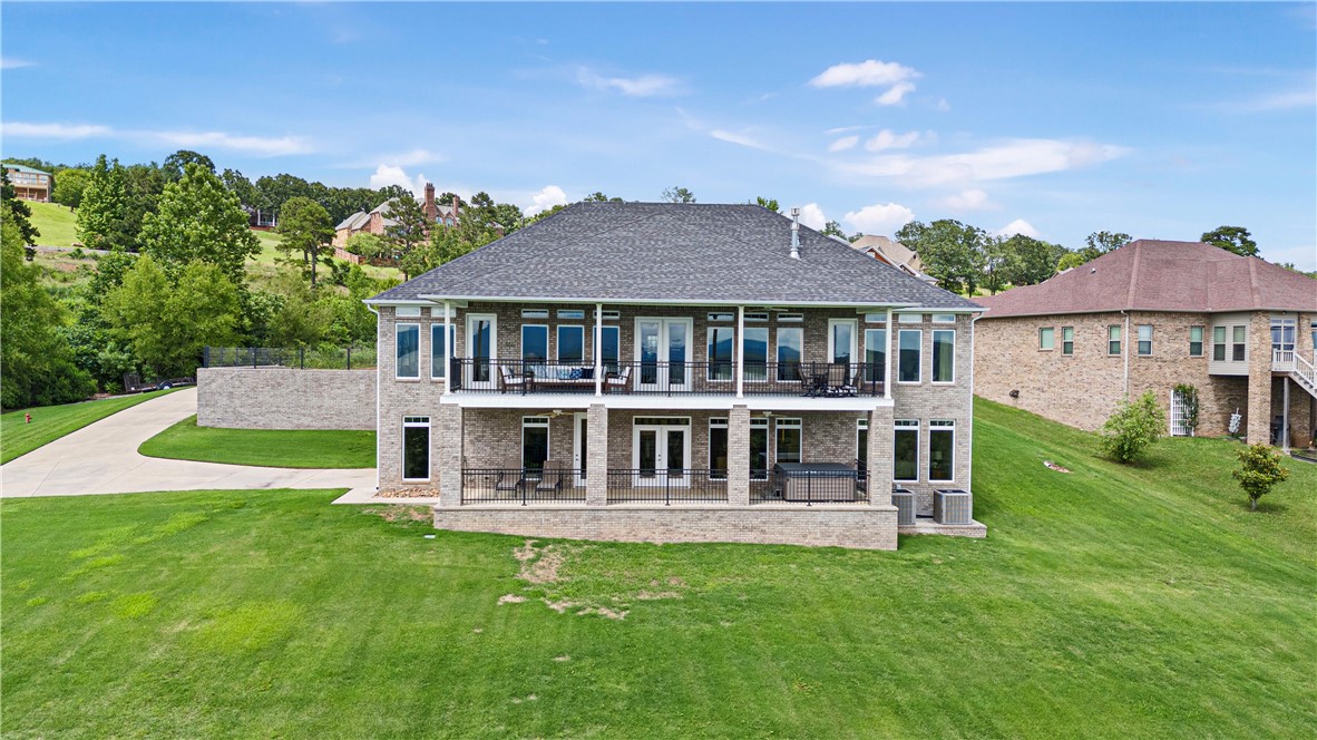 Breathtaking views of Lake Dardanelle, Mt. Nebo, Mt. Magazine, and Petit Jean Mountain! This magnificent 2-story estate offers unparalleled living, blending sophisticated elegance with comfortable living with 5 bedrooms and 5 full bathrooms.
Open-concept living features 10' ceilings on the main level, 9' ceilings on the lower level, and 8' doors throughout. Floor-to-ceiling tinted windows creating an airy, light-filled ambiance. Beautiful fireplaces make the living areas perfect for cozy evenings. The gourmet kitchen features granite countertops, exquisite cabinetry, and walk-in pantry. Gorgeous sunroom with natural views is just off the dining and living areas. Lower level includes living area, two additional bedrooms, mini-kitchen, fireplace, and dedicated safe room.
Upper and lower back decks provide space for dining, entertaining, or just enjoying awe-inspiring views.
2 tankless gas hot water heaters looped for instant hot water. Schedule your private showing today.